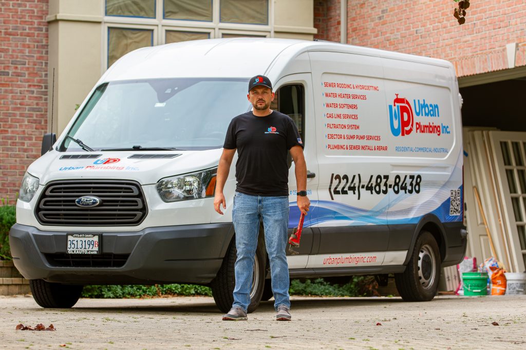 Professional plumber in Lake Zurich standing beside an Urban Plumbing Inc. service van, ready to provide expert plumbing repair and installation services.