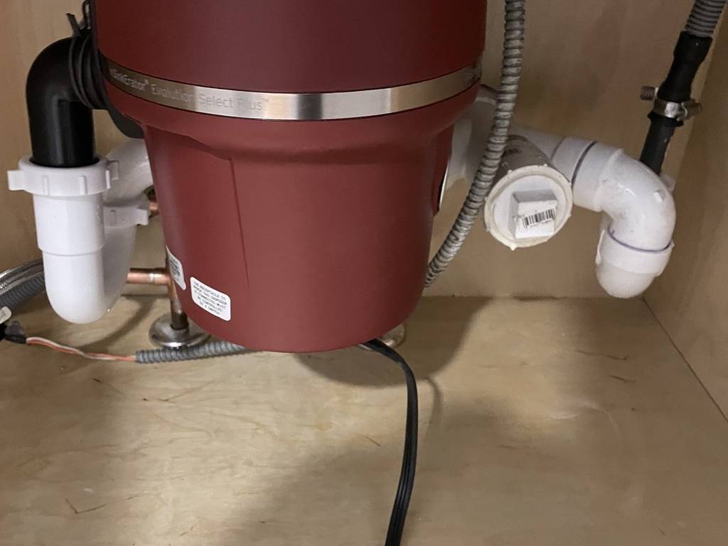 Garbage disposal installed under a kitchen sink by Urban Plumbing